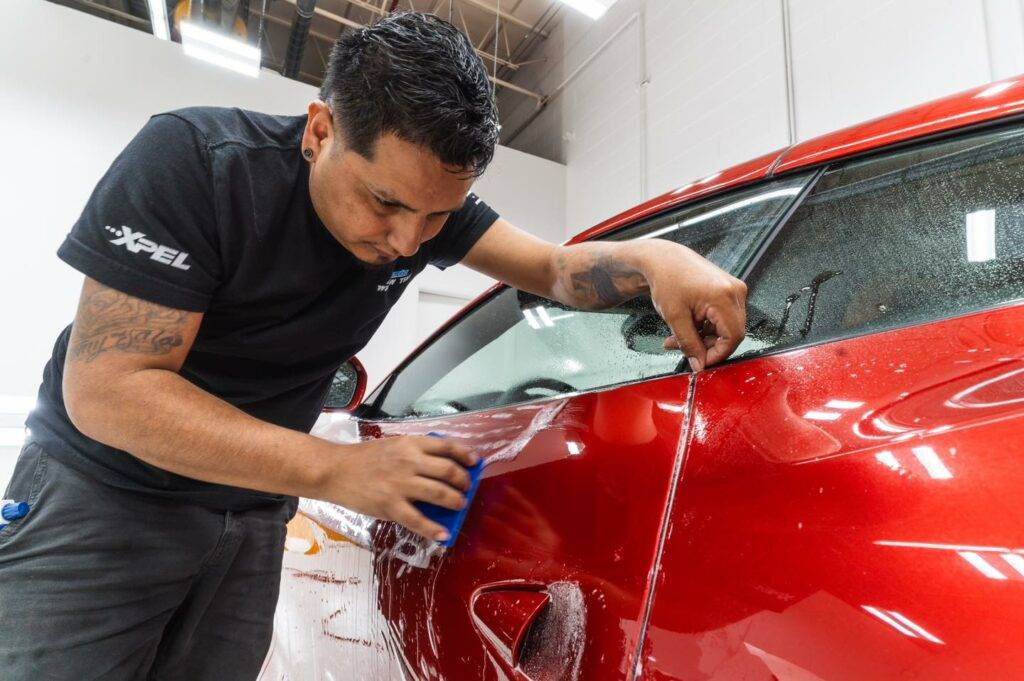 Picture of red Ferrari getting paint protection film