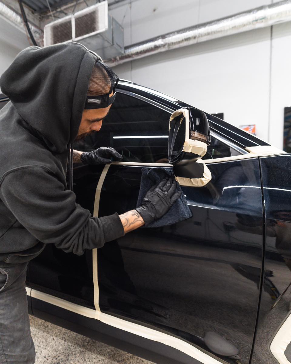 picture of tech polishing black car paint