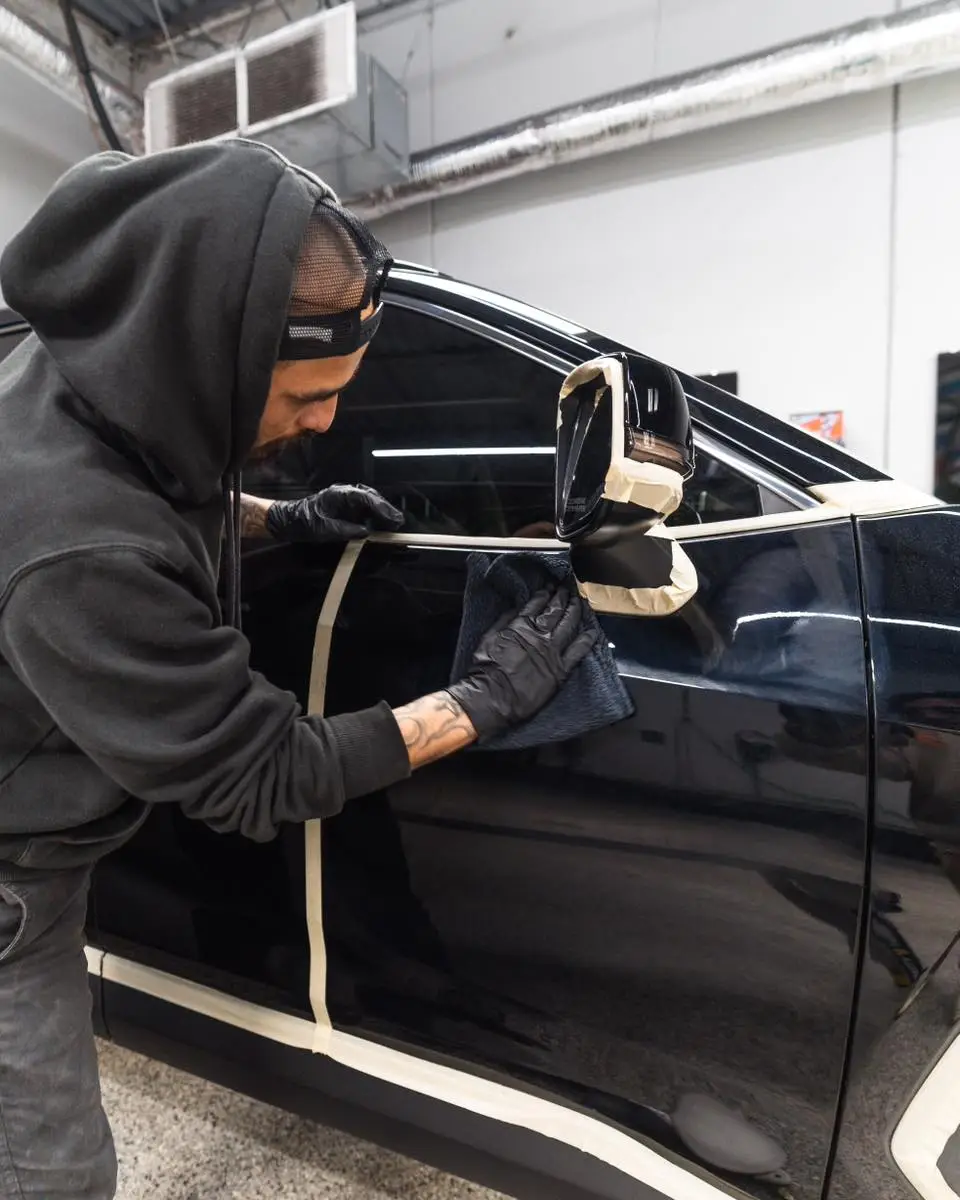 picture of tech polishing black car paint