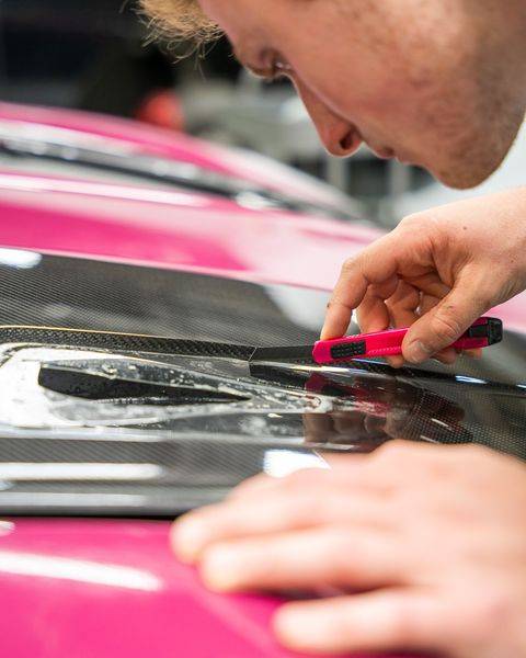 Picture of technician trimming PPF on a car