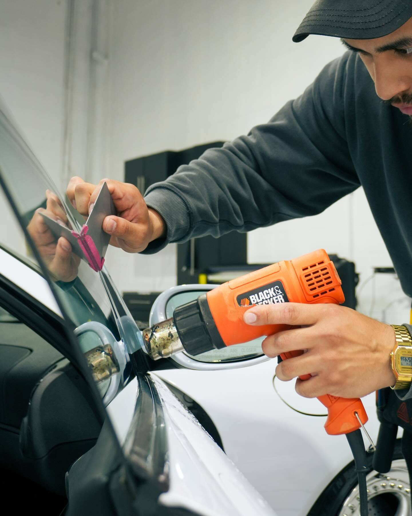 Precision heat shrinking window tint on the side glass window of the Porsche 911 Carrera