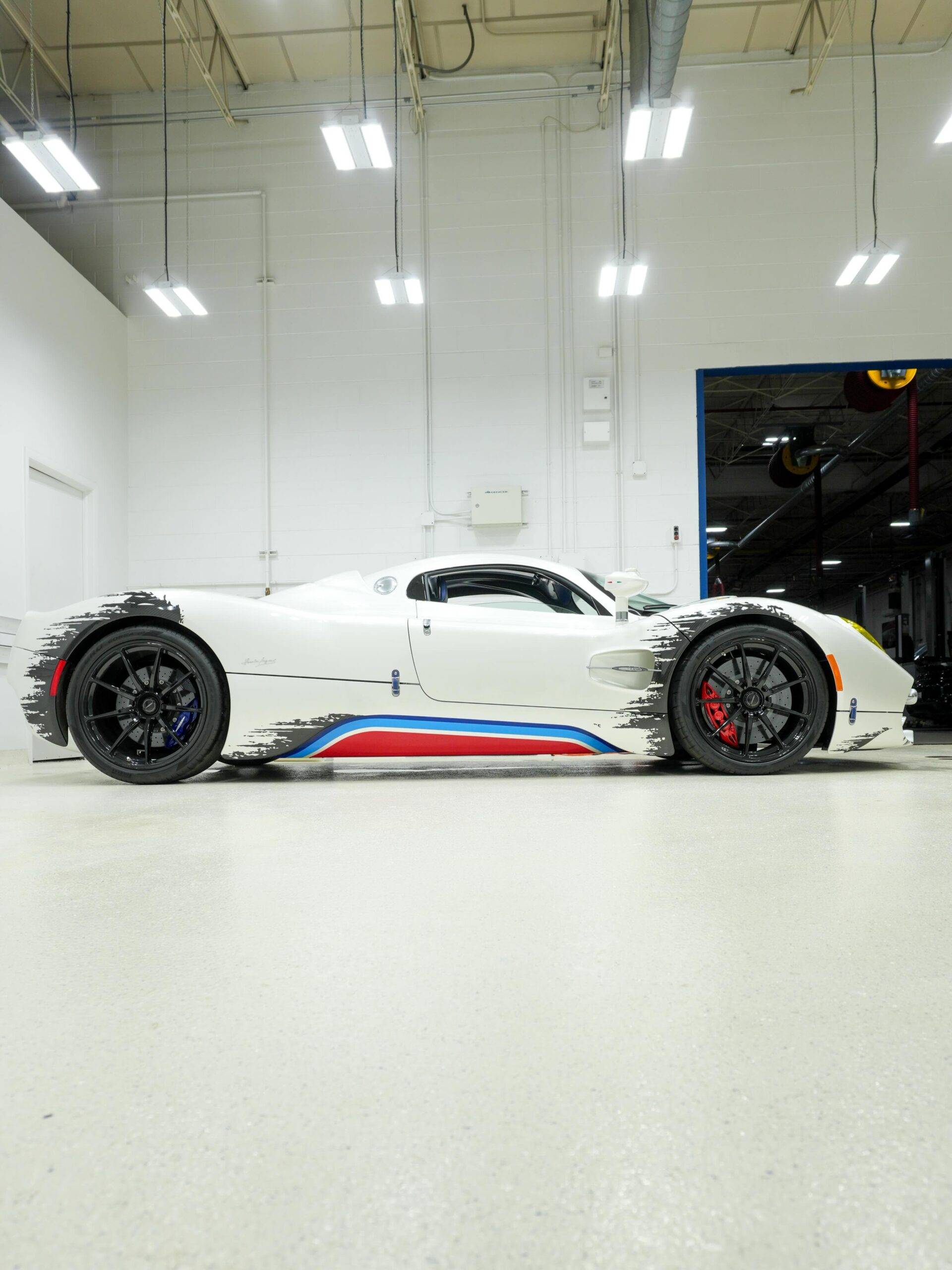 Side profile shot of the fully protected white Pagani Utopia hypercar