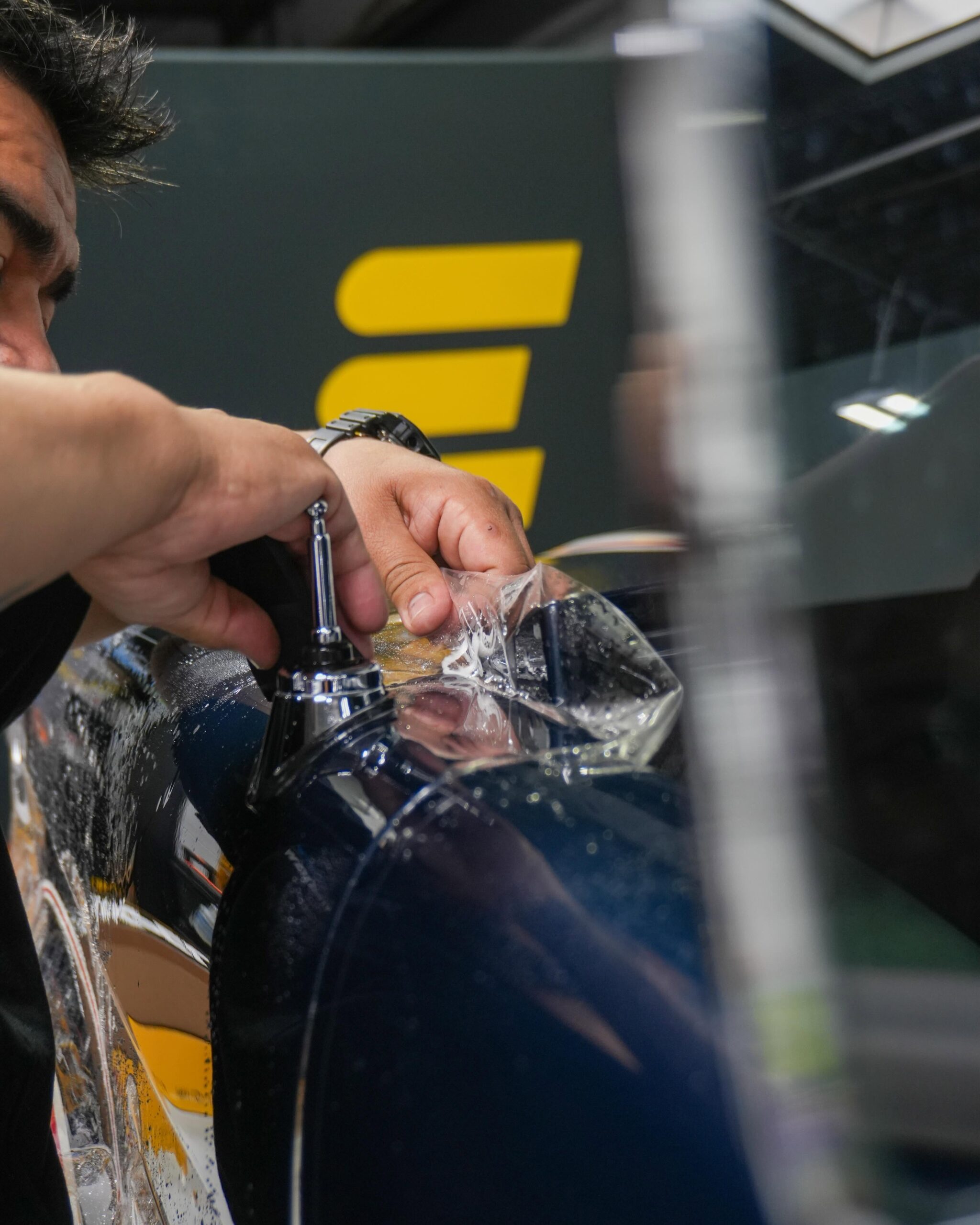 Expert installer applying self-healing clear bra to Bronco hood in Chicagoland