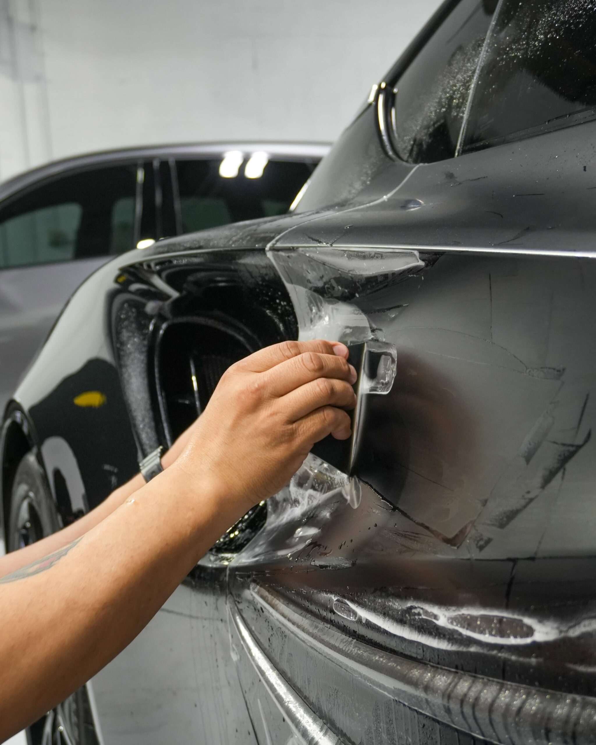 Squeegee Application of XPEL Stealth on Lotus Emira