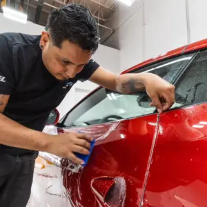 Picture of red Ferrari getting paint protection film